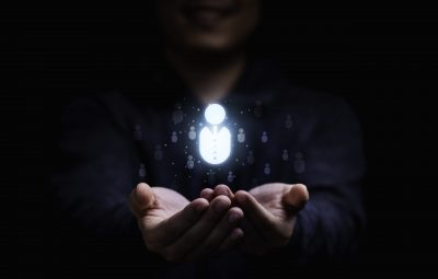 Businessman holding virtual human icon for focus customer group or human recruitment and development concept.