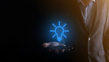 businessman-suit-with-light-bulb-his-hands-holds-phone-smartphone-tablet-glowing-idea-icon-his-hand2