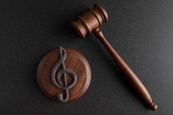 music-symbol-treble-clef-judge-gavel-black-background-music-copyright-infringement-music-piracyx